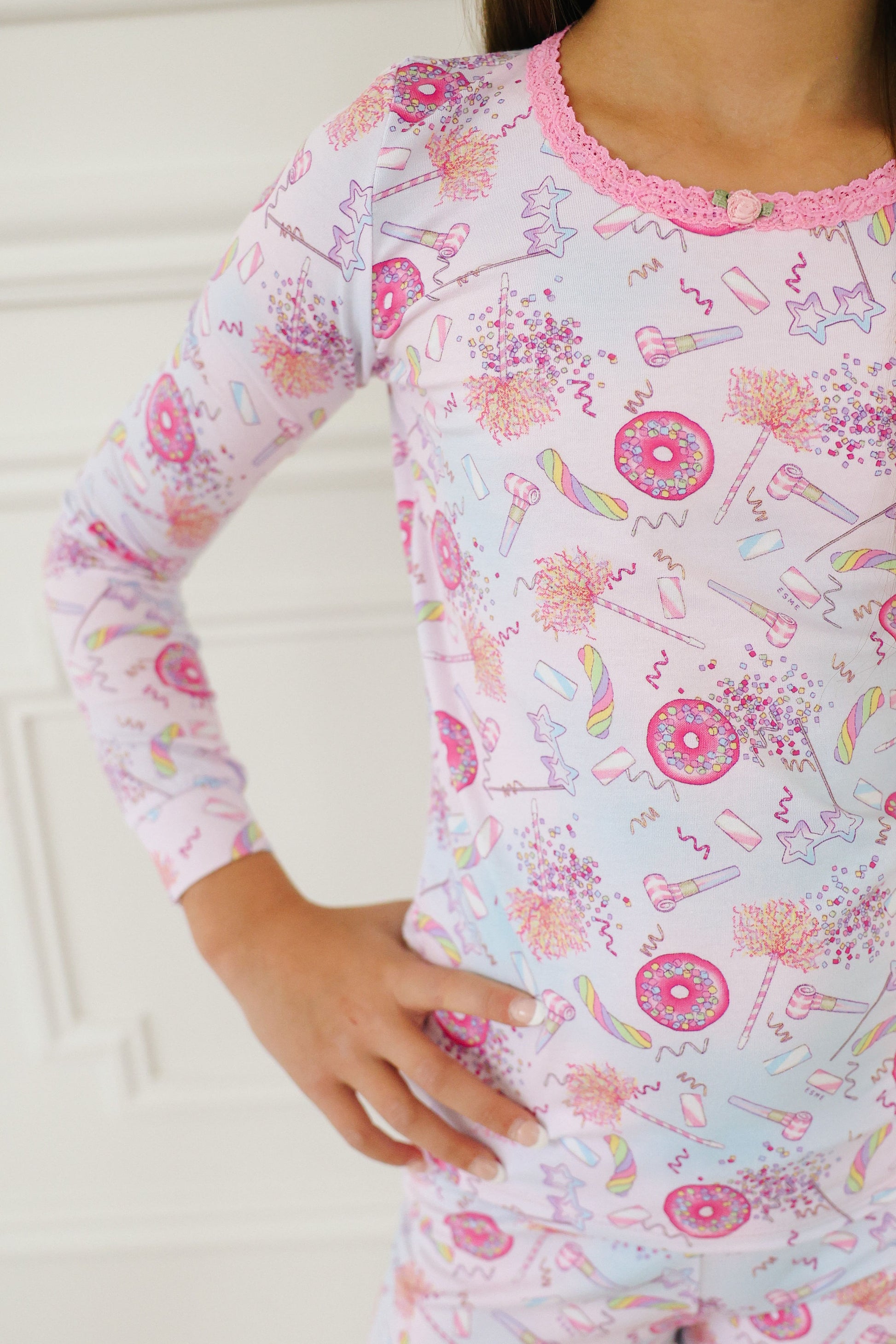 Esme girls long sleeve pajamas in pink. Design is festive, confetti and donuts
