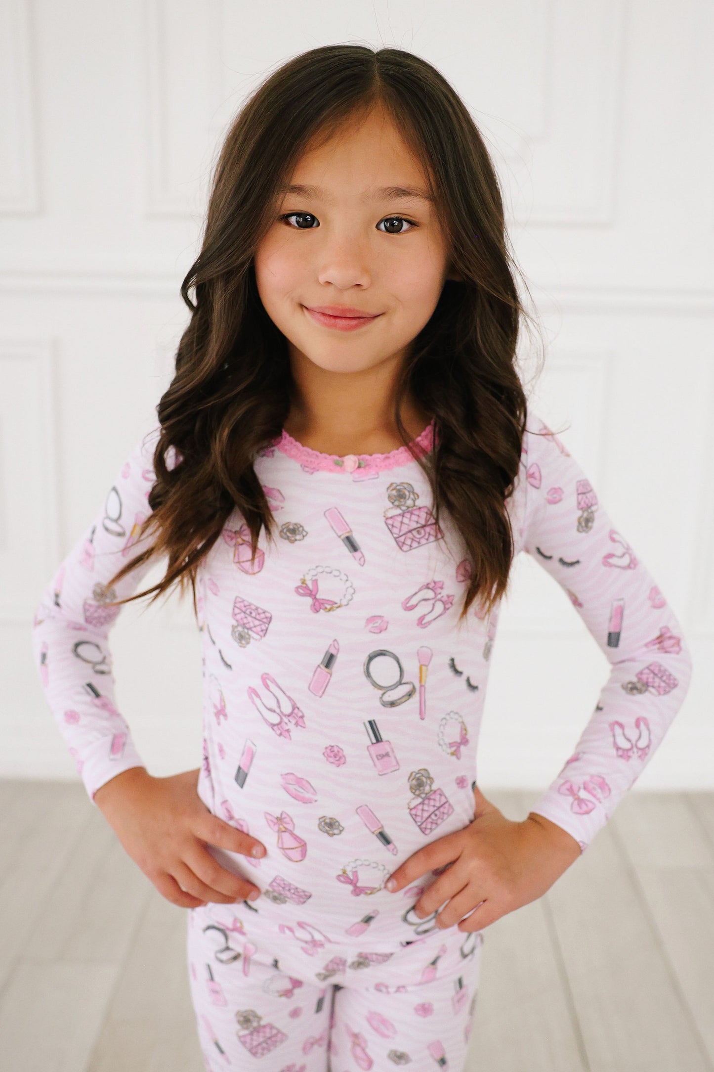 Esme girl slong sleeve pajamas in pink, design is glam with makeup items.