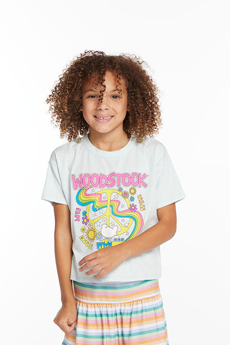 Model image of a girl in a light blue t-shirt with a peace sign and 'Woodstock' printed on the front