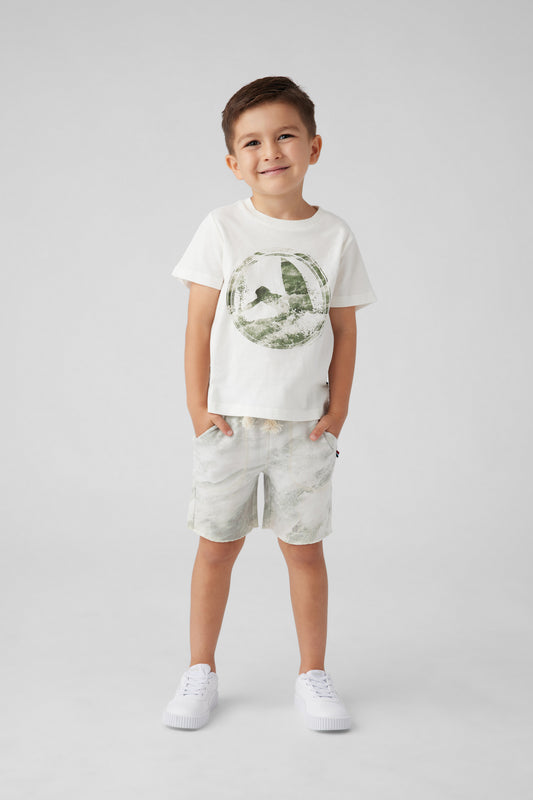 Model image of boy in a white t-shirt and shorts. T-Shirt design has a distressed surfer on the front. Shorts are distressed  to match the t-shirt