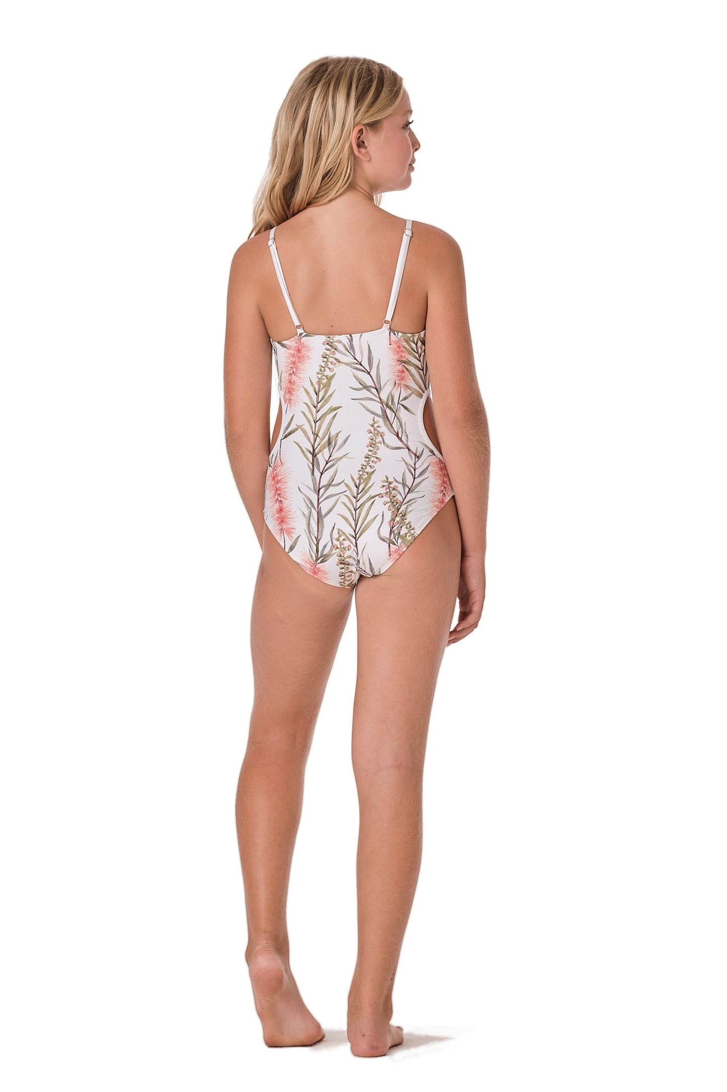 Model image of a cut out one piece swim suit for girls. Print is white with floral and paradise like designs